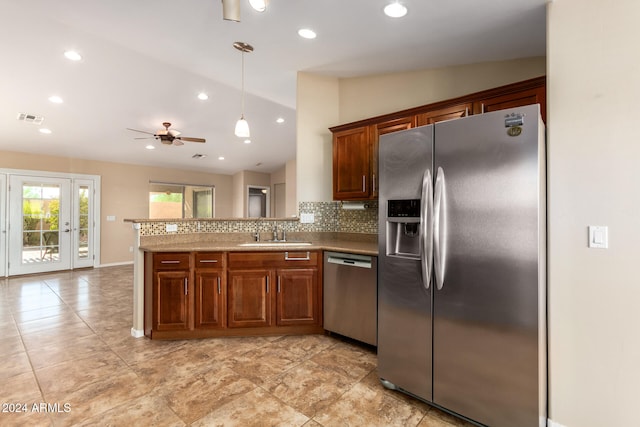 kitchen with tasteful backsplash, sink, ceiling fan, stainless steel appliances, and lofted ceiling