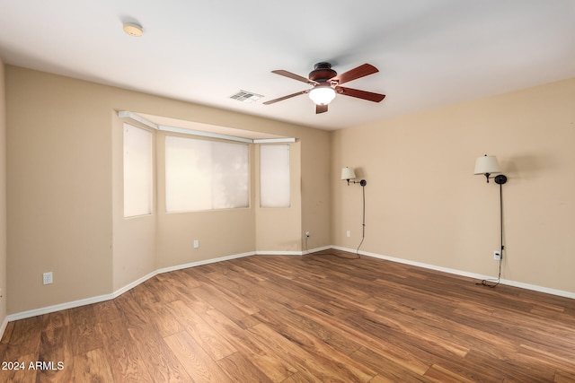 empty room featuring wood-type flooring and ceiling fan