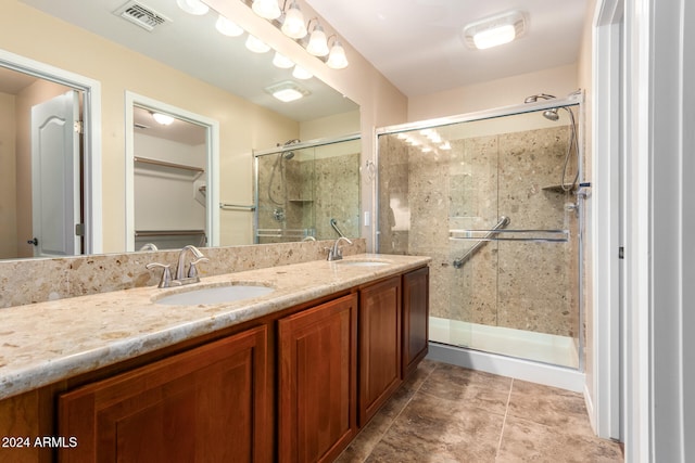 bathroom with vanity, tile patterned flooring, and an enclosed shower