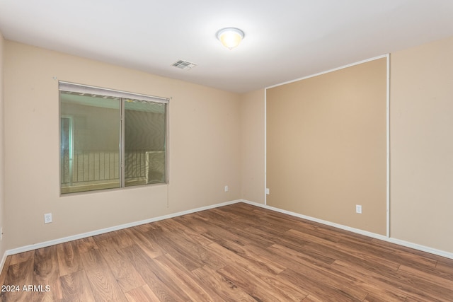 empty room with hardwood / wood-style flooring