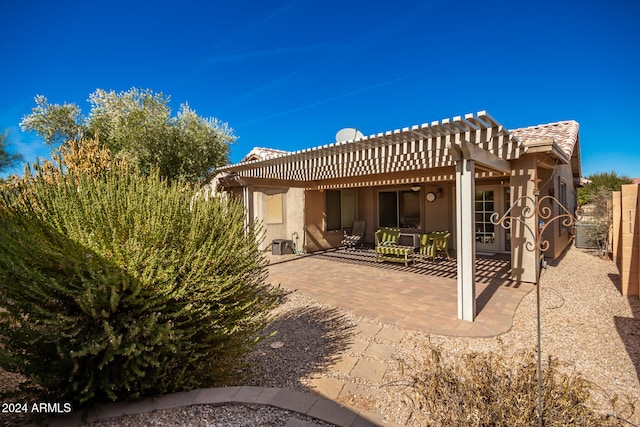 back of property featuring a patio area and a pergola