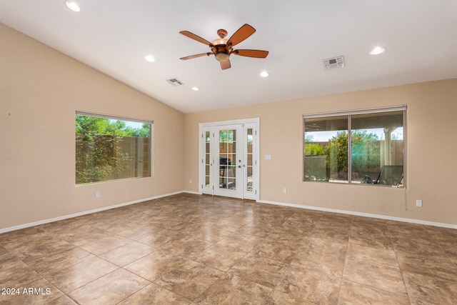 spare room with lofted ceiling, french doors, and ceiling fan