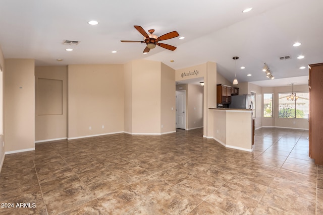 unfurnished living room with lofted ceiling and ceiling fan with notable chandelier