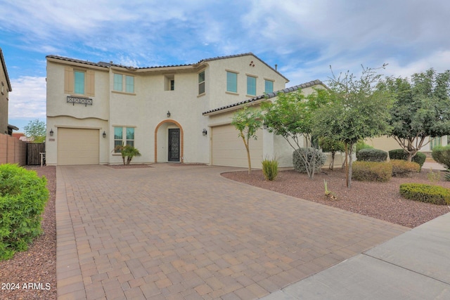 mediterranean / spanish-style home with a garage