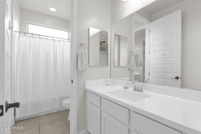 full bathroom featuring tile patterned flooring, shower / tub combo, vanity, and toilet