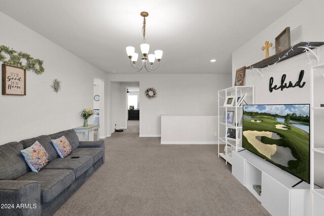 living room with carpet floors and a chandelier