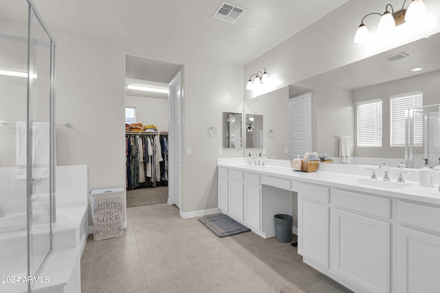 bathroom with vanity, a shower with door, and tile patterned floors