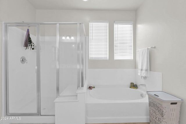 bathroom featuring separate shower and tub