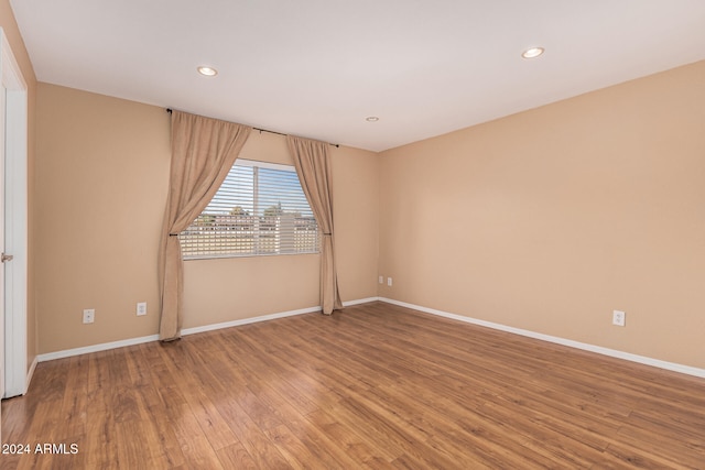 unfurnished room with hardwood / wood-style floors