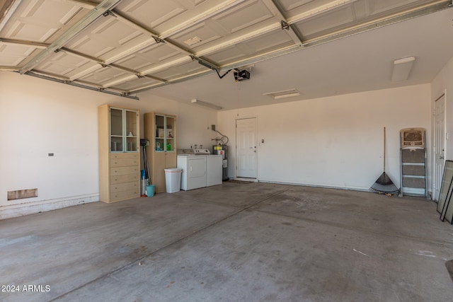 garage with washer and clothes dryer, electric water heater, and a garage door opener