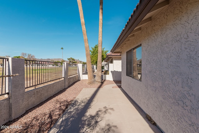 view of side of home with a patio area