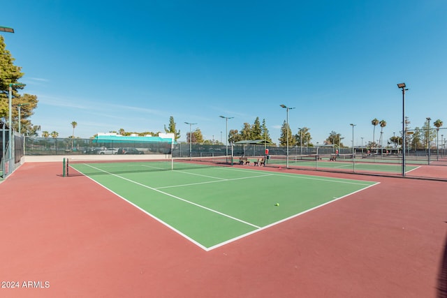 view of tennis court featuring basketball hoop