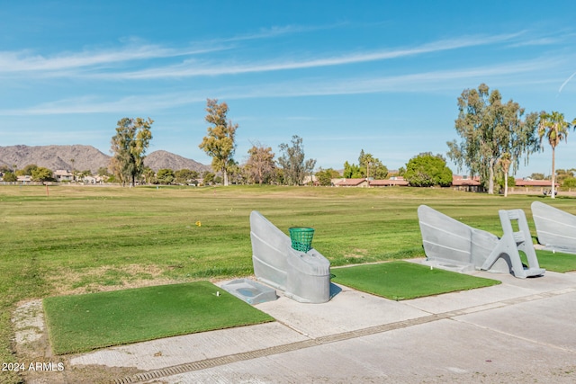 view of community featuring a lawn and a mountain view