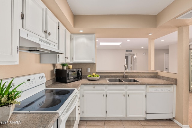 kitchen featuring white cabinetry, sink, light tile patterned flooring, and white appliances