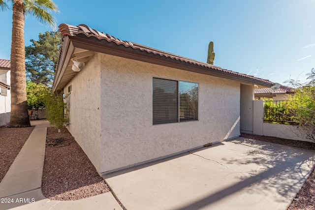 view of property exterior with a patio