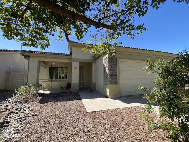 10817 W Wilshire Dr, Avondale, AZ 85392 - view of front of property featuring a tiled roof, stucco siding, and an attached garage