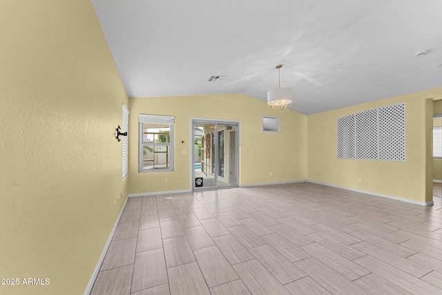 10817 W Wilshire Dr, Avondale, AZ 85392 - spare room featuring lofted ceiling, baseboards, visible vents, and wood tiled floor