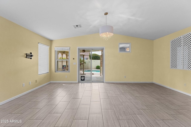 10817 W Wilshire Dr, Avondale, AZ 85392 - unfurnished room featuring baseboards, visible vents, wood finish floors, an inviting chandelier, and lofted ceiling