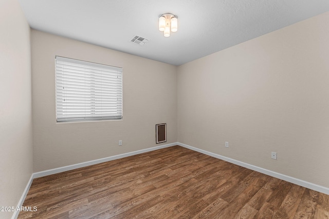 10817 W Wilshire Dr, Avondale, AZ 85392 - spare room with visible vents, baseboards, and wood finished floors