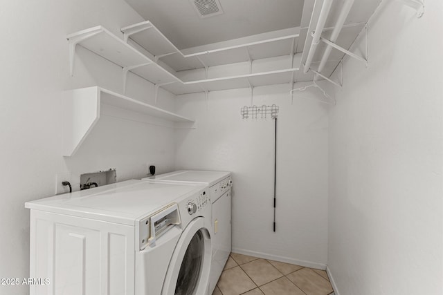 10817 W Wilshire Dr, Avondale, AZ 85392 - washroom featuring laundry area, light tile patterned flooring, separate washer and dryer, and visible vents