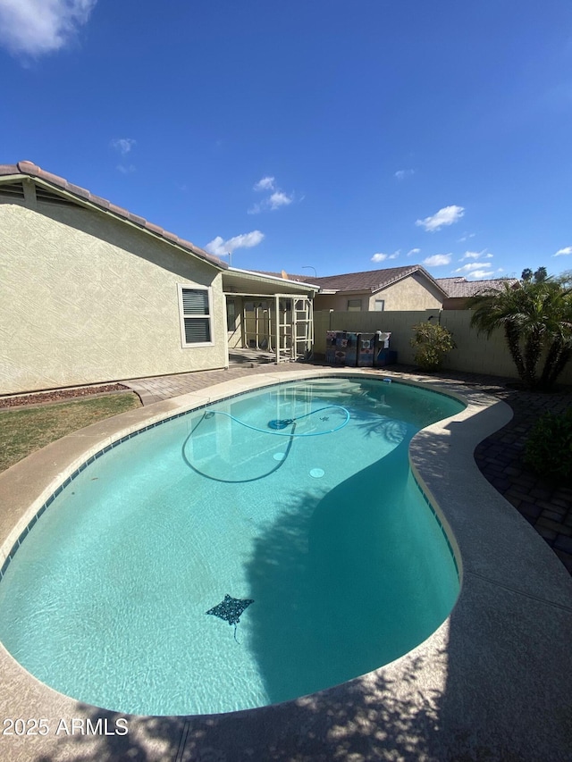 10817 W Wilshire Dr, Avondale, AZ 85392 - view of swimming pool featuring a patio area, a fenced backyard, a fenced in pool, and a sunroom