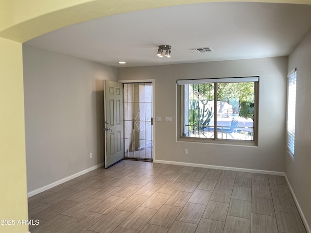 10817 W Wilshire Dr, Avondale, AZ 85392 - empty room featuring wood finished floors, baseboards, and visible vents