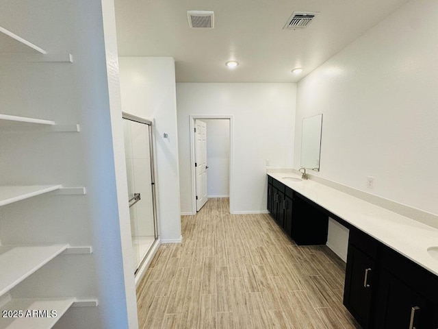 47267 W Mellen Ln, Maricopa, AZ 85139 - full bath featuring a stall shower, vanity, wood finished floors, and baseboards