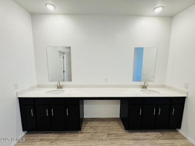 47267 W Mellen Ln, Maricopa, AZ 85139 - bathroom with wood tiled floors, double vanity, and baseboards
