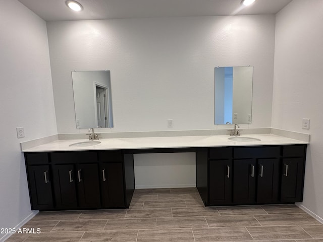 47267 W Mellen Ln, Maricopa, AZ 85139 - bathroom featuring vanity, wood finish floors, baseboards, and recessed lighting