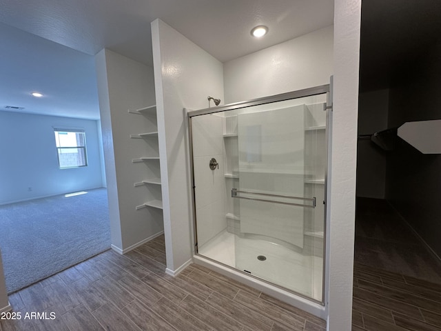 47267 W Mellen Ln, Maricopa, AZ 85139 - bathroom with wood finished floors, a stall shower, and baseboards