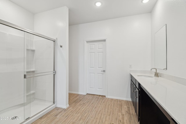 47267 W Mellen Ln, Maricopa, AZ 85139 - full bath with vanity, a stall shower, wood finished floors, baseboards, and recessed lighting