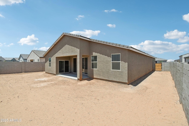 47267 W Mellen Ln, Maricopa, AZ 85139 - back of house with stucco siding, a fenced backyard, and a patio area