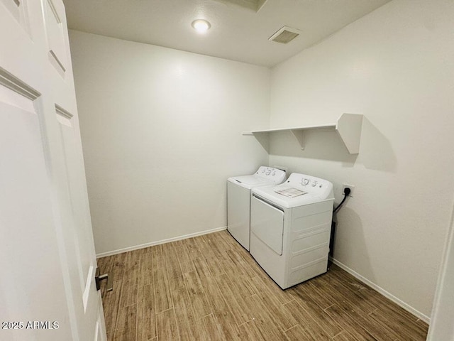 47267 W Mellen Ln, Maricopa, AZ 85139 - washroom featuring light wood-style floors, washing machine and clothes dryer, baseboards, and recessed lighting