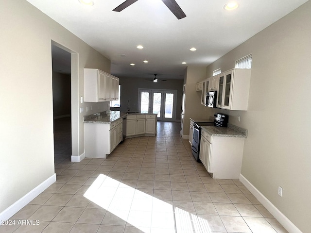 kitchen with kitchen peninsula, white cabinets, ceiling fan, and appliances with stainless steel finishes