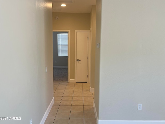 hall featuring light tile patterned flooring