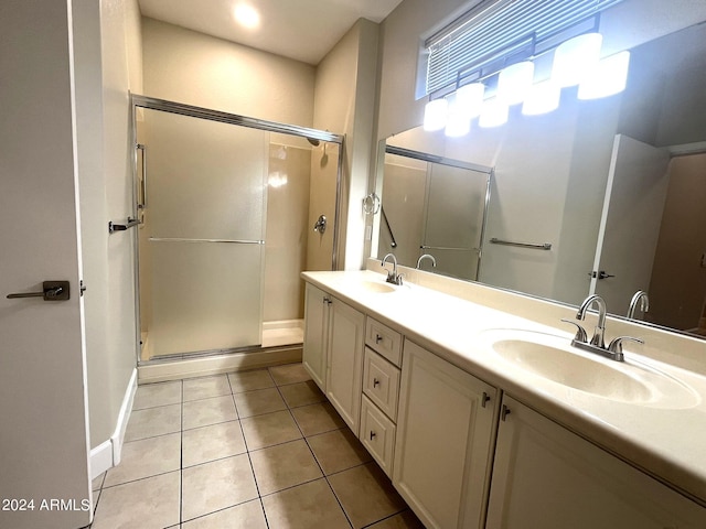 bathroom featuring vanity, tile patterned floors, and a shower with shower door