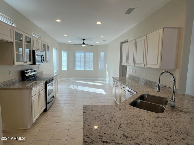 kitchen featuring ceiling fan, white cabinets, appliances with stainless steel finishes, and sink