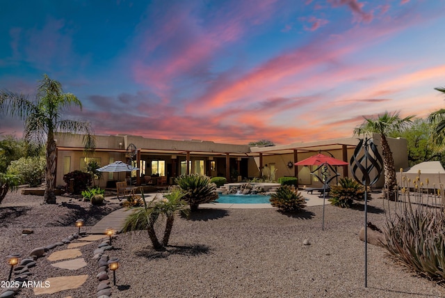 back of house with a patio area, an outdoor pool, and fence
