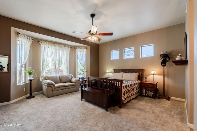 carpeted bedroom featuring baseboards and a ceiling fan