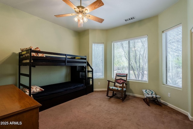 bedroom featuring visible vents, carpet, baseboards, and multiple windows