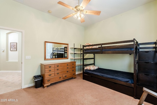 carpeted bedroom with baseboards and a ceiling fan