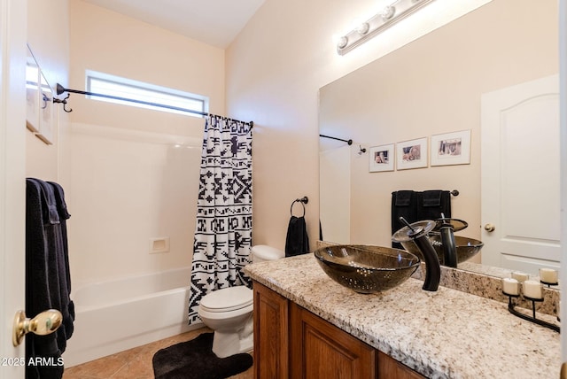 bathroom featuring vanity, tile patterned flooring, shower / bath combo with shower curtain, and toilet