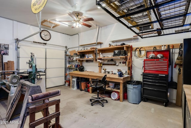 garage featuring a ceiling fan and a workshop area