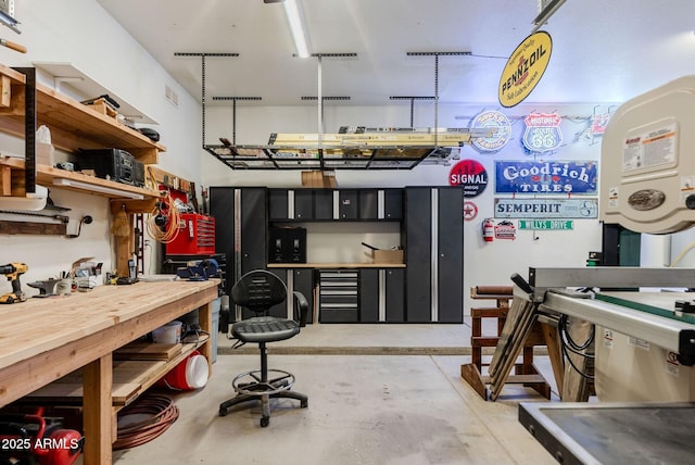 interior space featuring concrete flooring, a workshop area, and visible vents