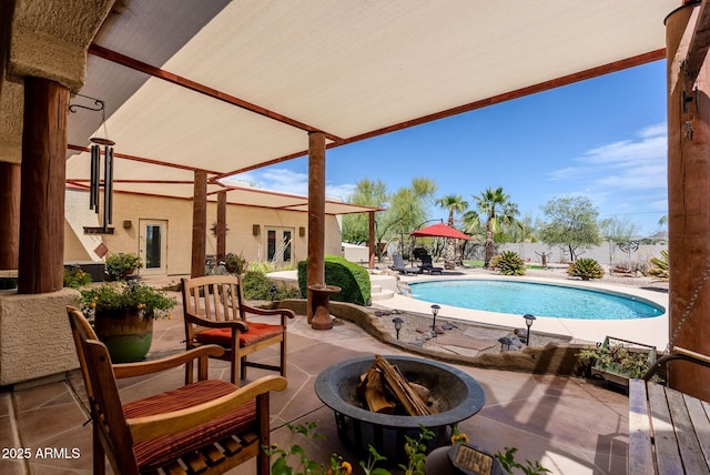 view of swimming pool featuring a patio, a fenced backyard, a fire pit, and a fenced in pool