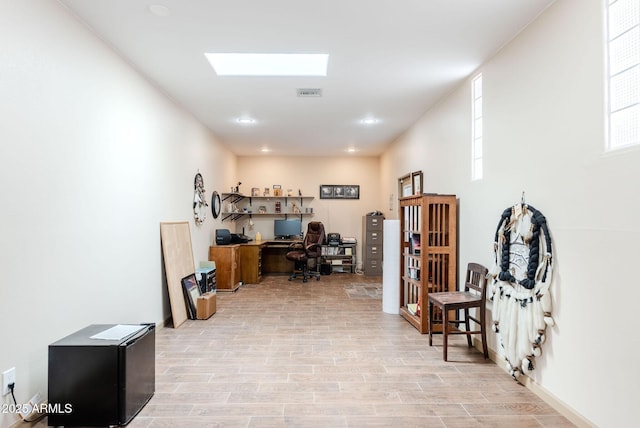 office space featuring visible vents and light wood-type flooring