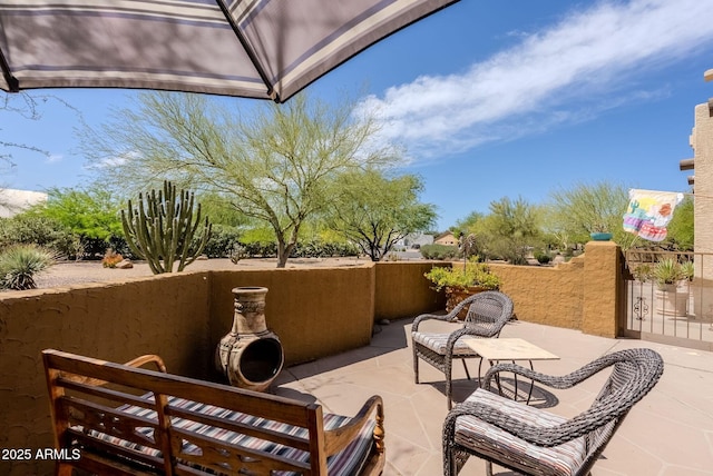 view of patio / terrace featuring fence