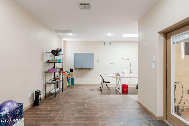 interior space with visible vents and wood finished floors