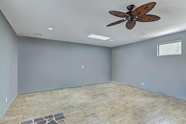 empty room featuring baseboards, a ceiling fan, wood finished floors, and visible vents