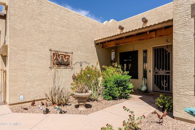 entrance to property with stucco siding